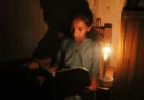student studying by candlelight in Sri Lanka